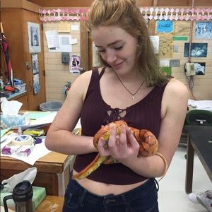 A wine colored tank with a lace up front